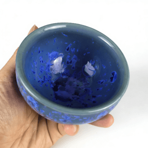 tenmoku-glaze-cup-tea-blue-inhand.png
