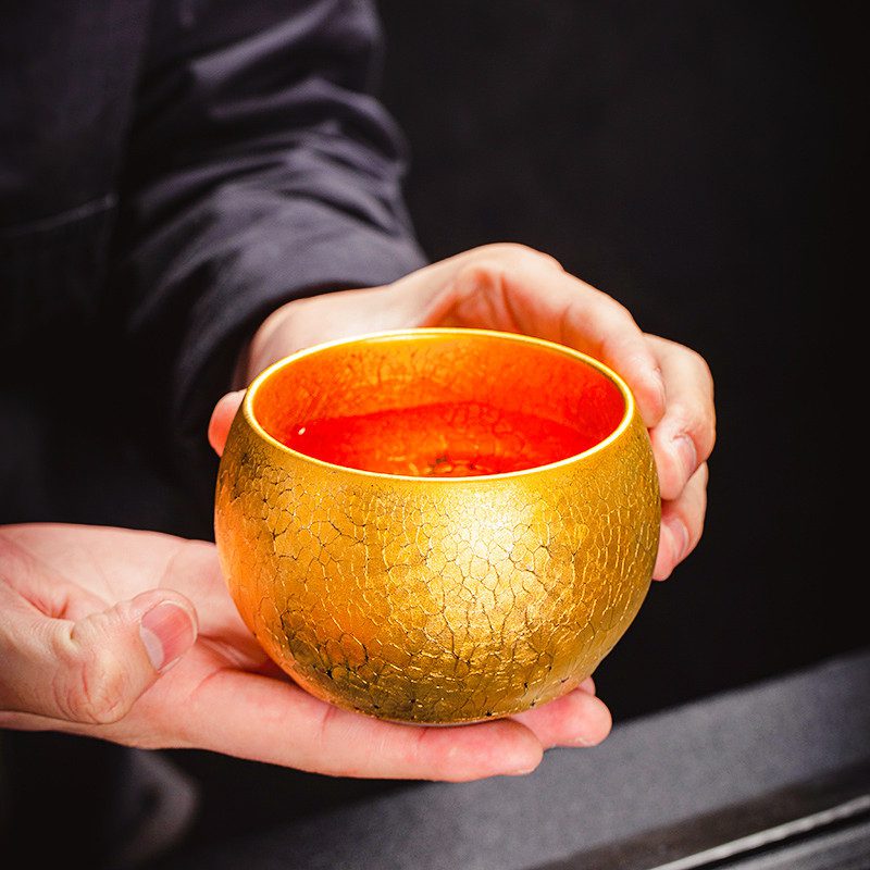 porcelain tea cups-tenmoku glaze-golden-sunburst-inhand porcelain tea cups-tenmoku glaze-golden-sunburst-inhand