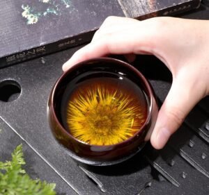 porcelain-tea-cups​-sand-gold-inhand
